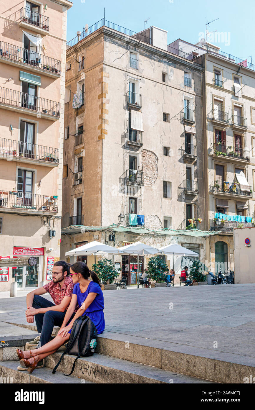 Barcelona Spain,Catalonia Ciutat Vella,historic center,Plaza de Joan Capri,public square,residential buildings,man,woman,young adults,couple,sitting o Stock Photo