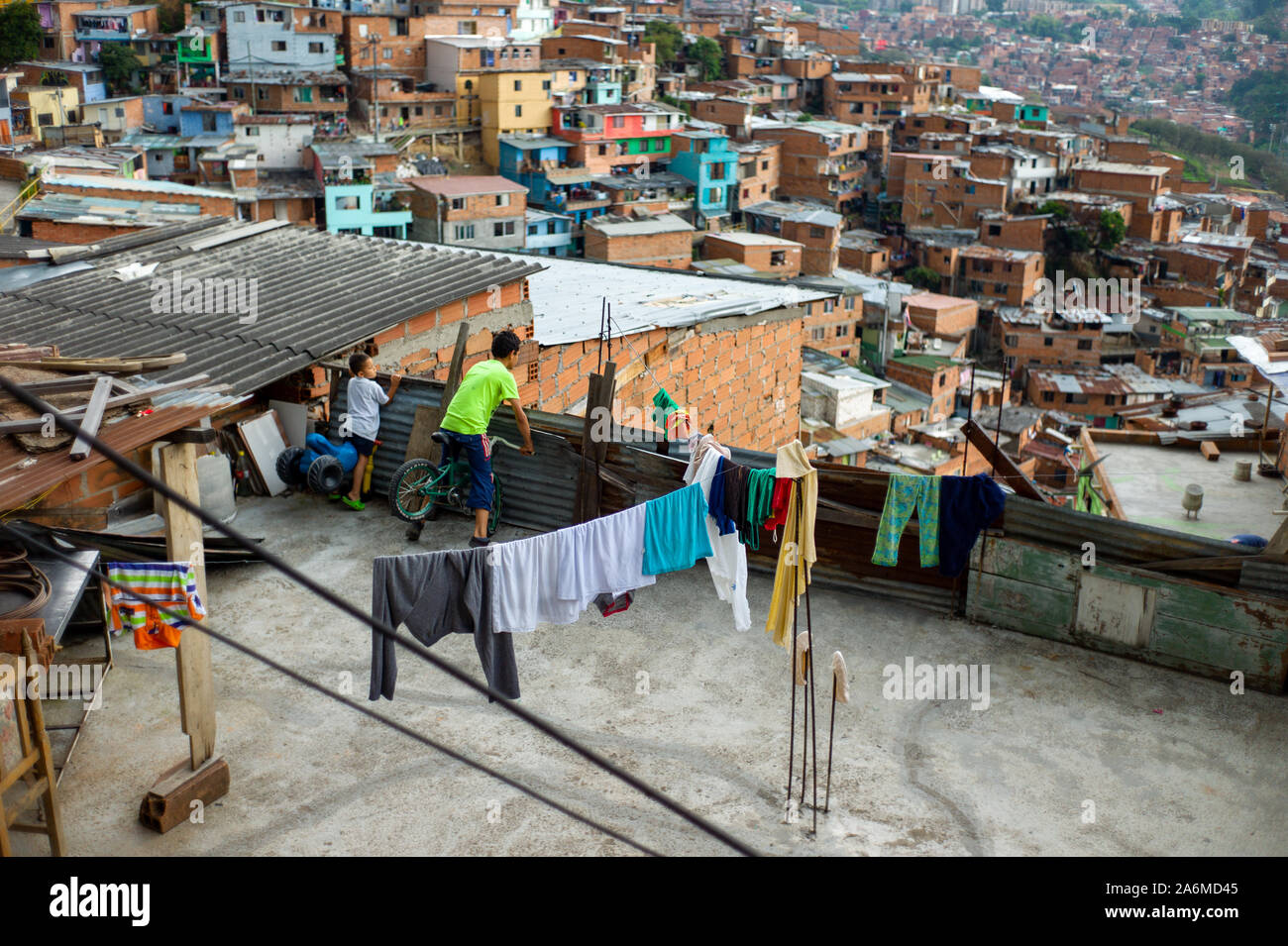 Medellin, Antioquia / Colombia; February 24 2019:  Child on Bicycle Watching on the Terrace of a House in Commune 13 Stock Photo