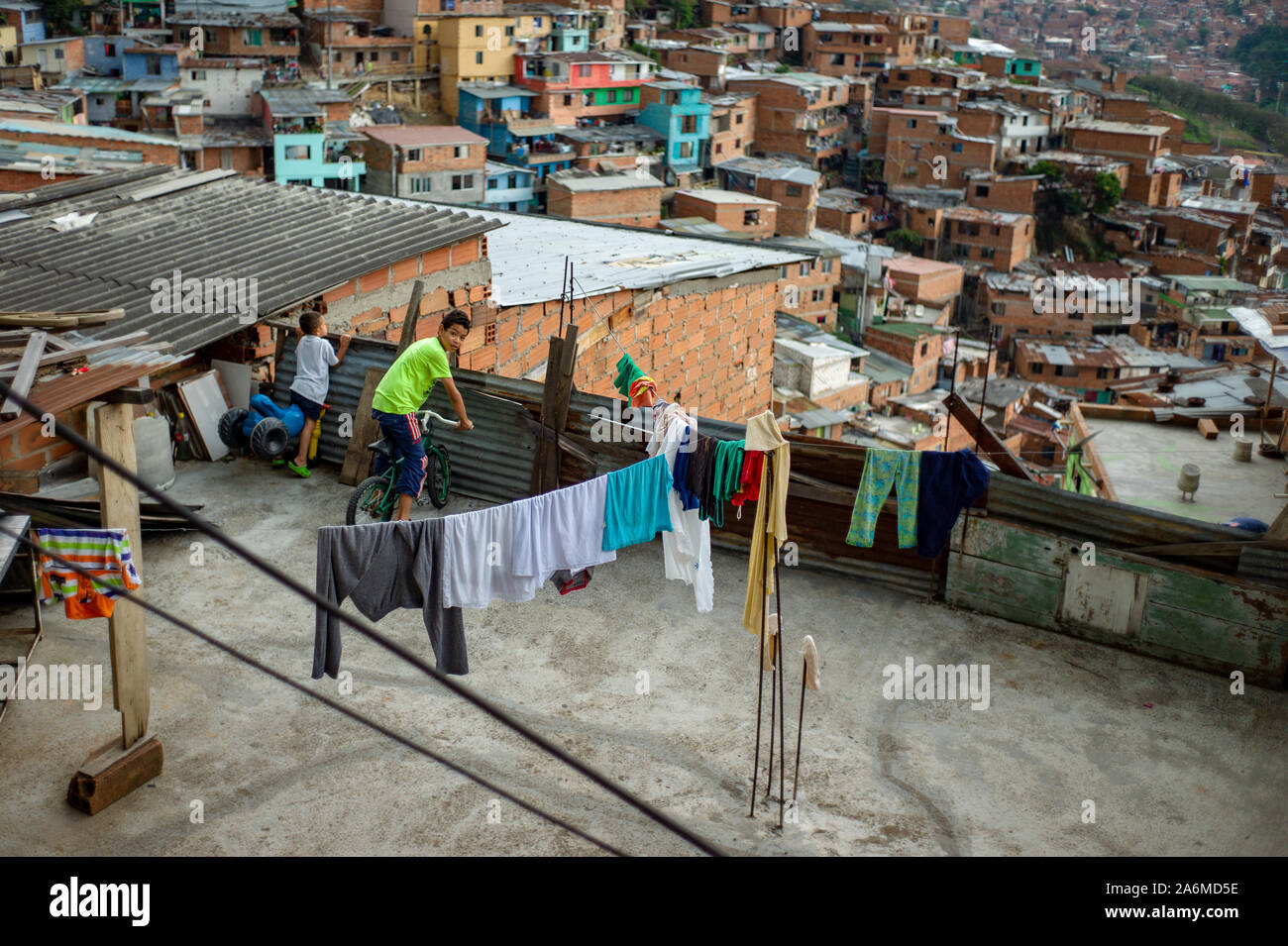 Medellin, Antioquia / Colombia; February 24 2019:  Child on Bicycle Watching on the Terrace of a House in Commune 13 Stock Photo