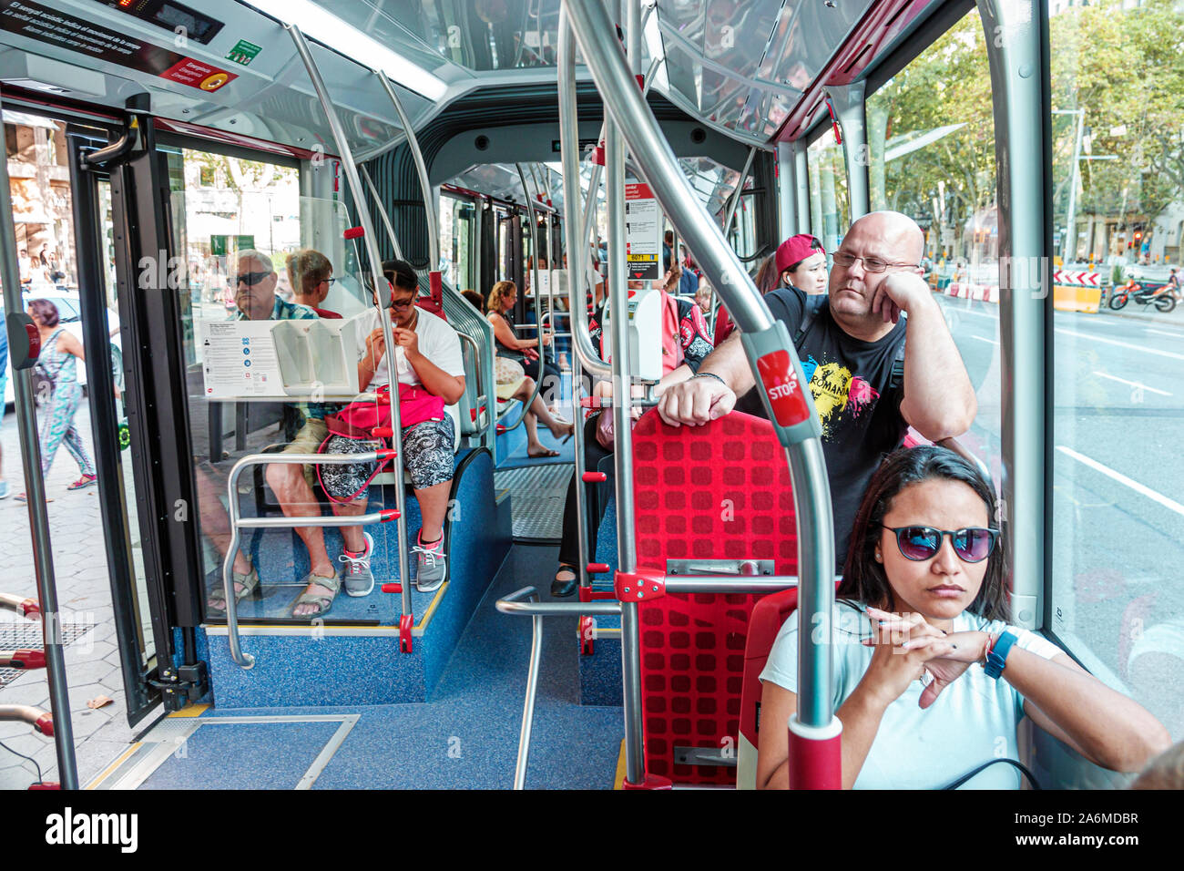 Barcelona Spain,Catalonia bus,Transports Metropolitans de Barcelona,TMB,inside,passengers riders commuters,sitting,woman,man,boy,Hispanic,Eurozone,ES1 Stock Photo