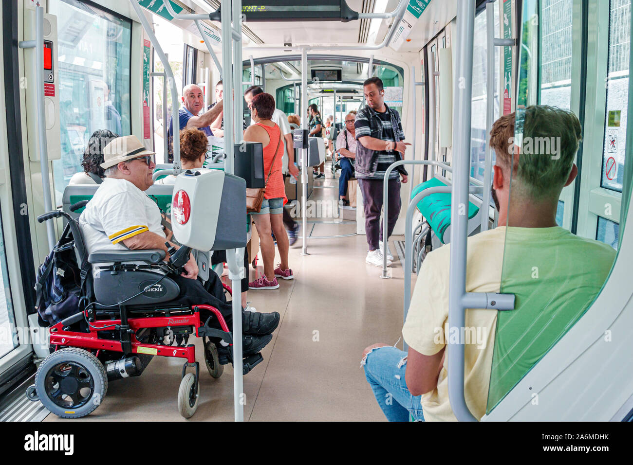 Barcelona Spain,Catalonia Les Corts,tram,exterior,Trambaix,light rail,inside,riders passengers,man,woman,disabled,wheelchair,accessibility,ES190904020 Stock Photo