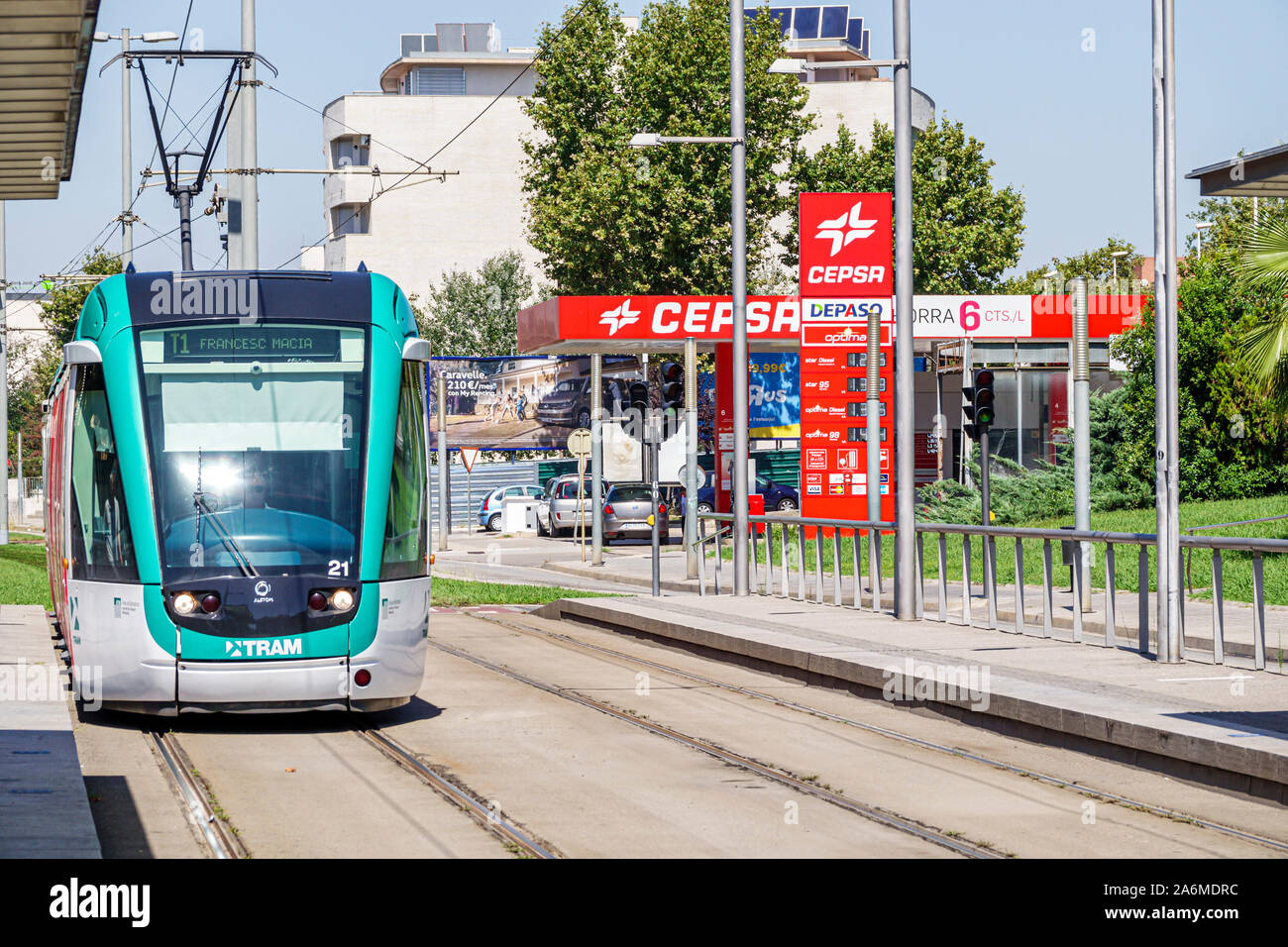 Barcelona Spain,Catalonia Cornella de Llobregat,tram,exterior,Trambaix,light rail,overhead line wire,catenary,track,Cepsa,Compania Espanola de Petrole Stock Photo