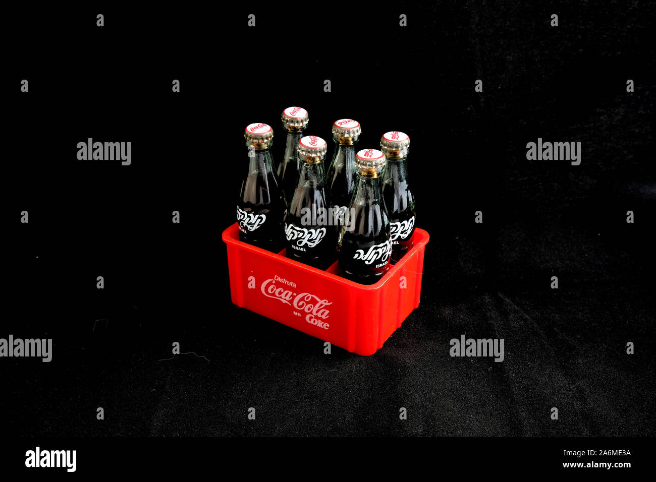 Miniature collectible glass Coca-Cola bottles from Israel in a red plastic Mexican Coca-Cola bottle crate; collectible distributed in Mexico. Stock Photo