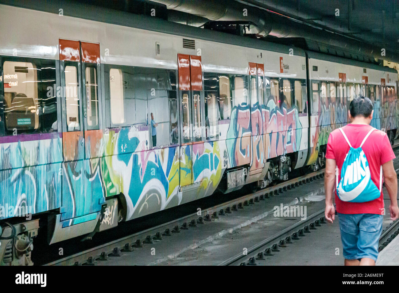 Barcelona Spain,Catalonia Sants-Montjuic,Barcelona - Sants Train railway station,inside,track,platform,train,graffiti,man,passenger commuter,ES1909050 Stock Photo