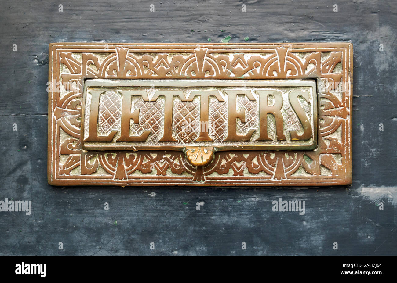 Ornate letter box on a wooden door, Lancaster, Lancashire, England, UK. Stock Photo