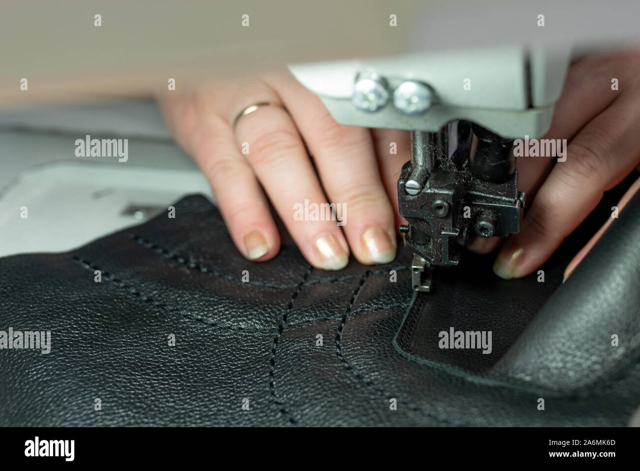 The process of sewing shoes on a sewing machine. Shoe production Stock