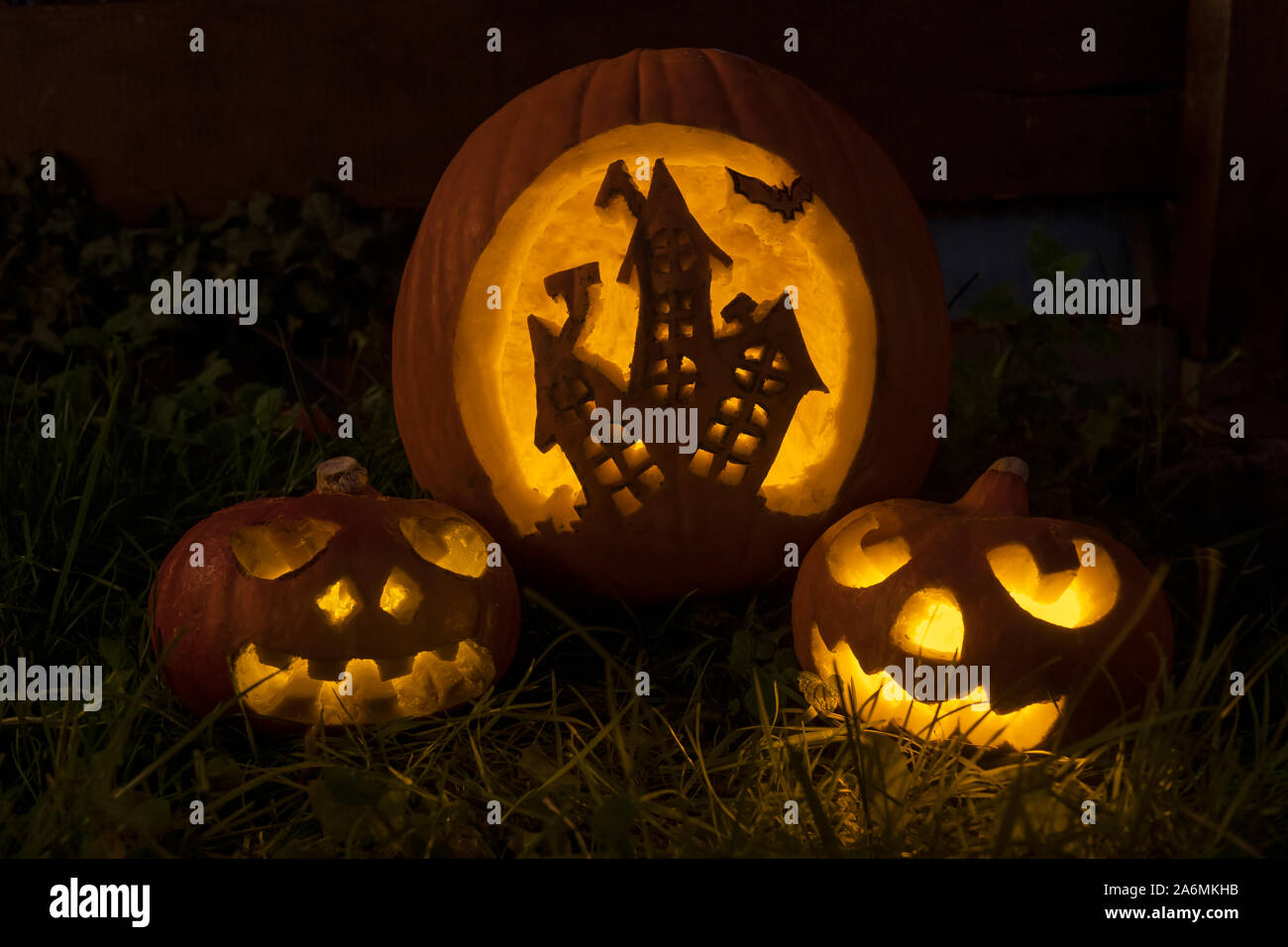 Funny halloween pumpkins with scary house and faces Stock Photo