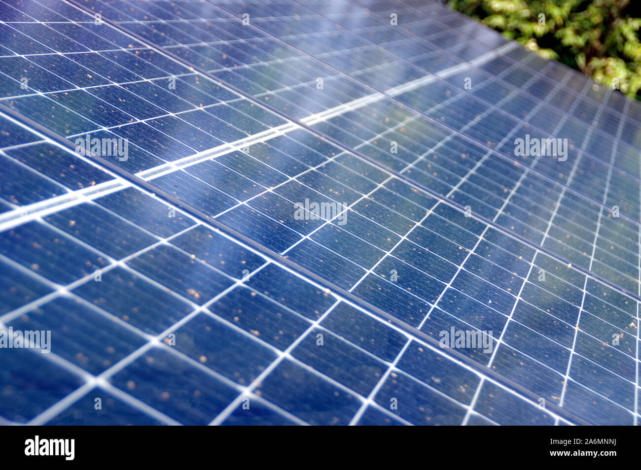 Photovoltaic panels on house roof. Alternative and renewable energy, green power, ecology and solar electricity production. Stock Photo