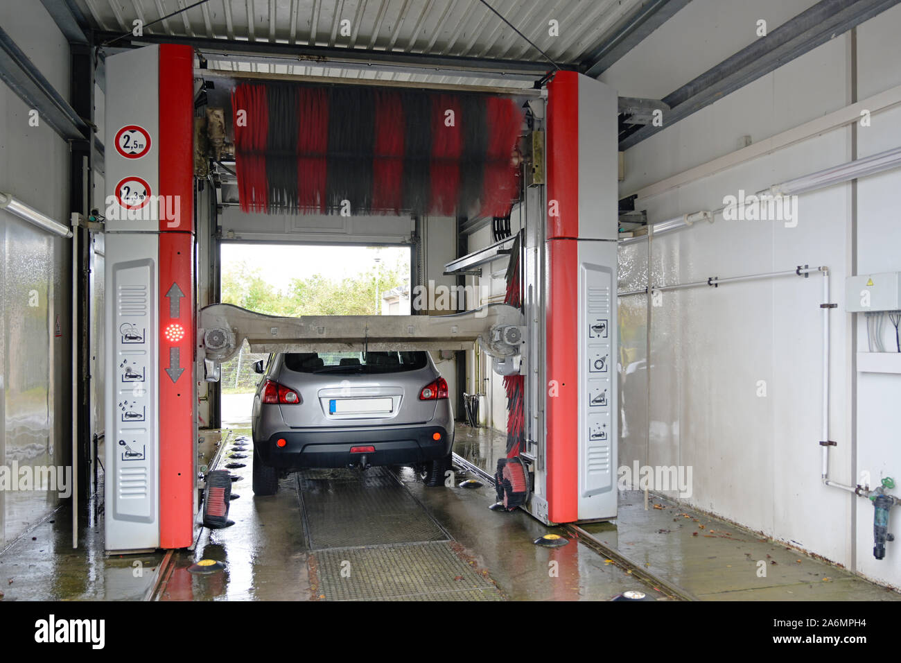 car in an automatic wash station, mechanized washing facility with textile brushes and air drying Stock Photo