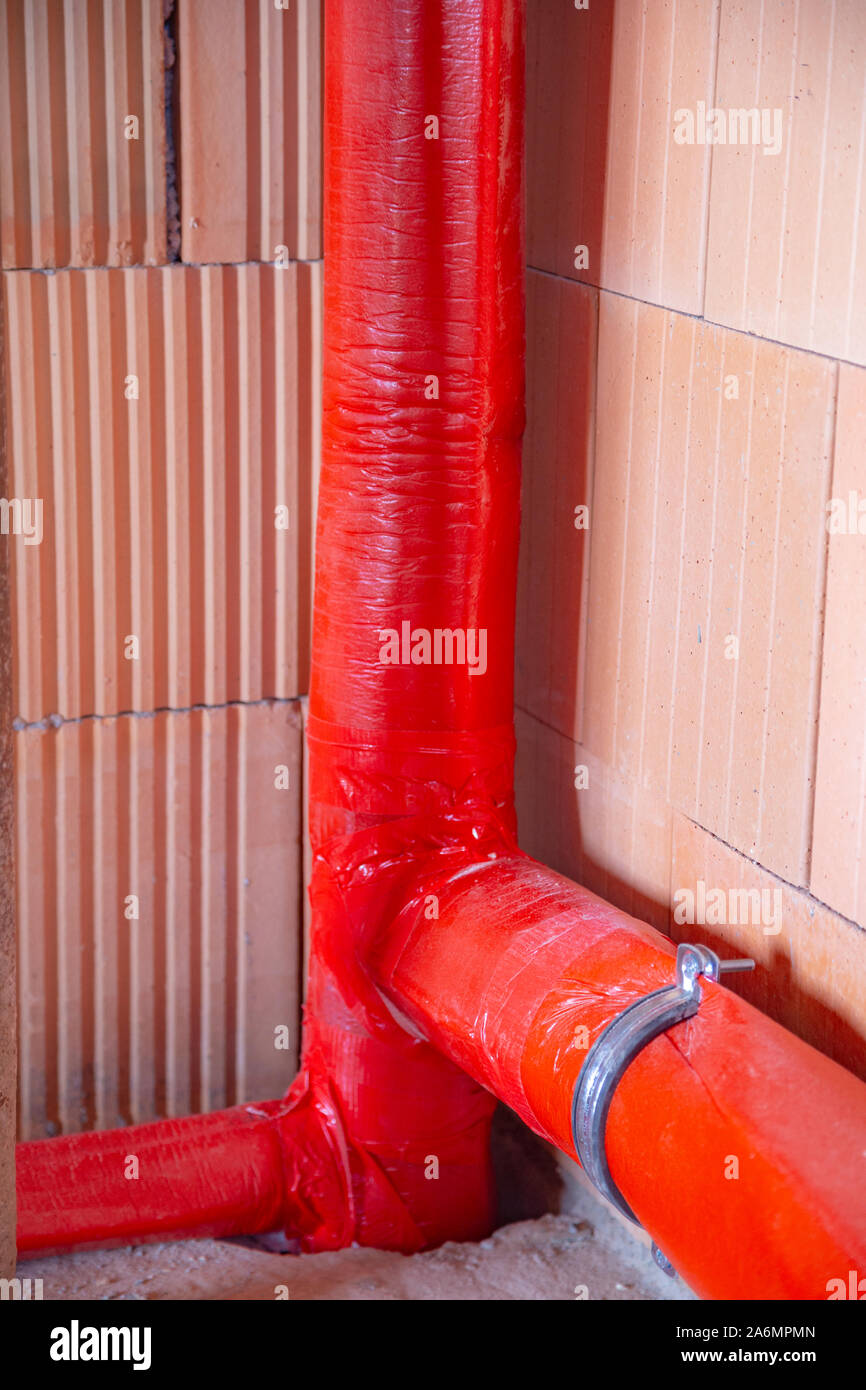 Soundproofed drain pipe in a house which is under construction Stock Photo