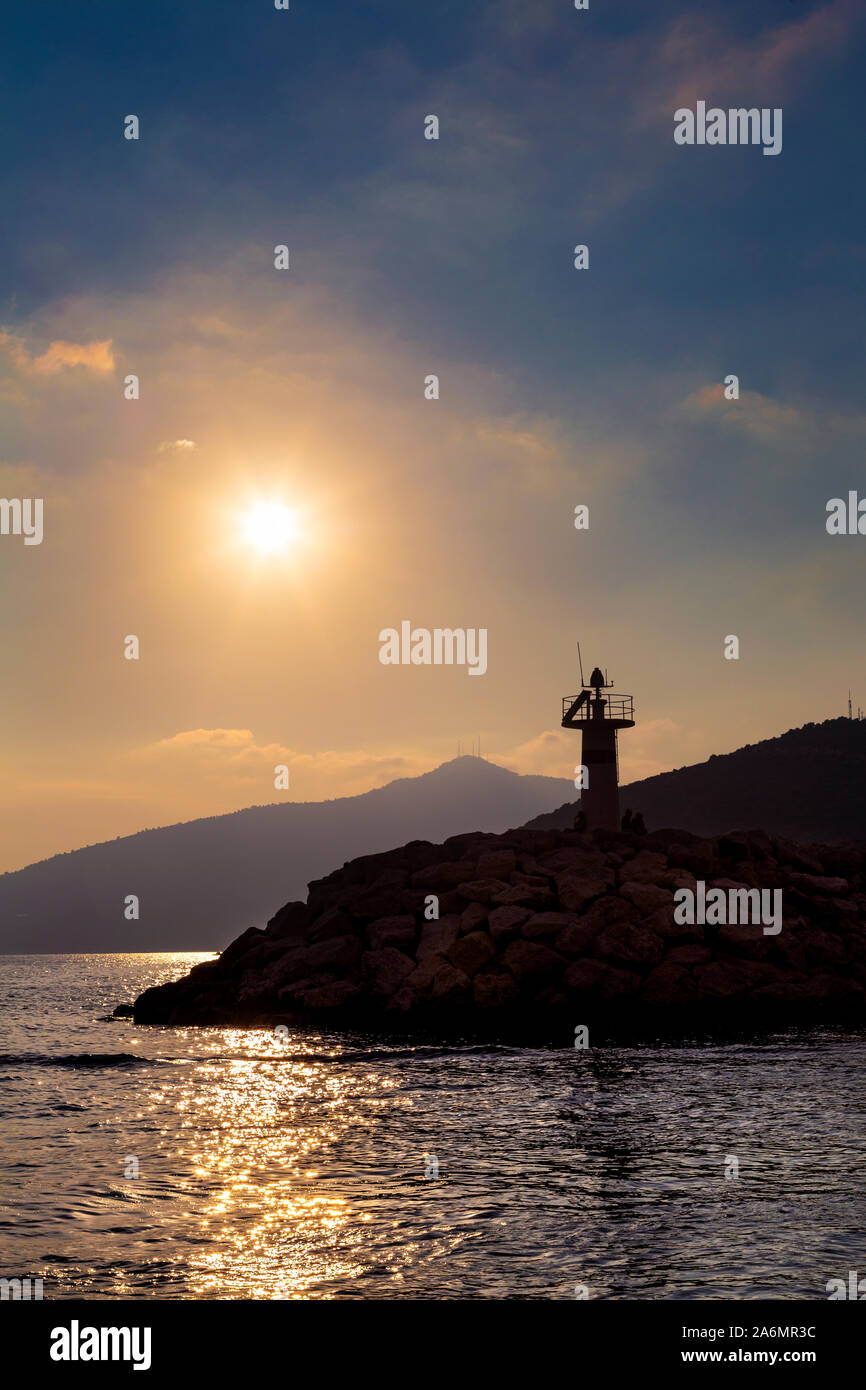 The lighthouse at sunset in the harbour town and popular tourist destination of Kalkan, Turkish Riviera, Turkey Stock Photo