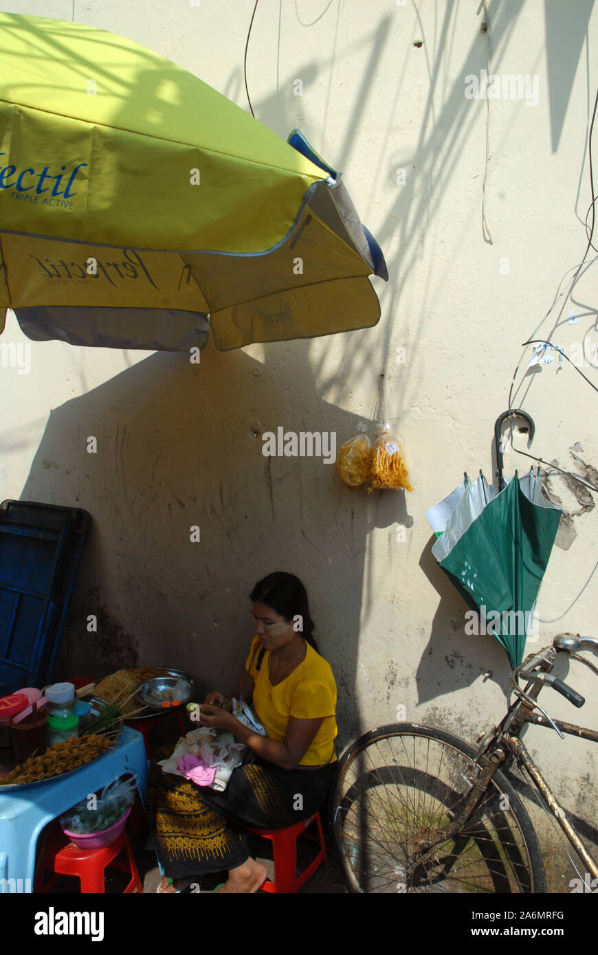 Old umbrella giving shade, Yangon, Myanmar, Asia. Stock Photo