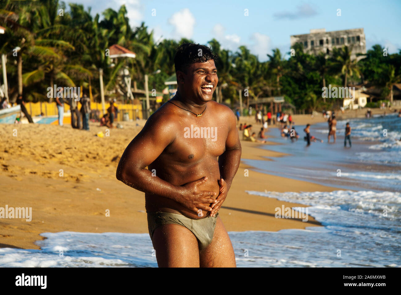 A Man Laughs Out Holding His Stomach At Mount Lavinia Beach Colombo Sri Lanka May 26 2007 Stock Photo Alamy