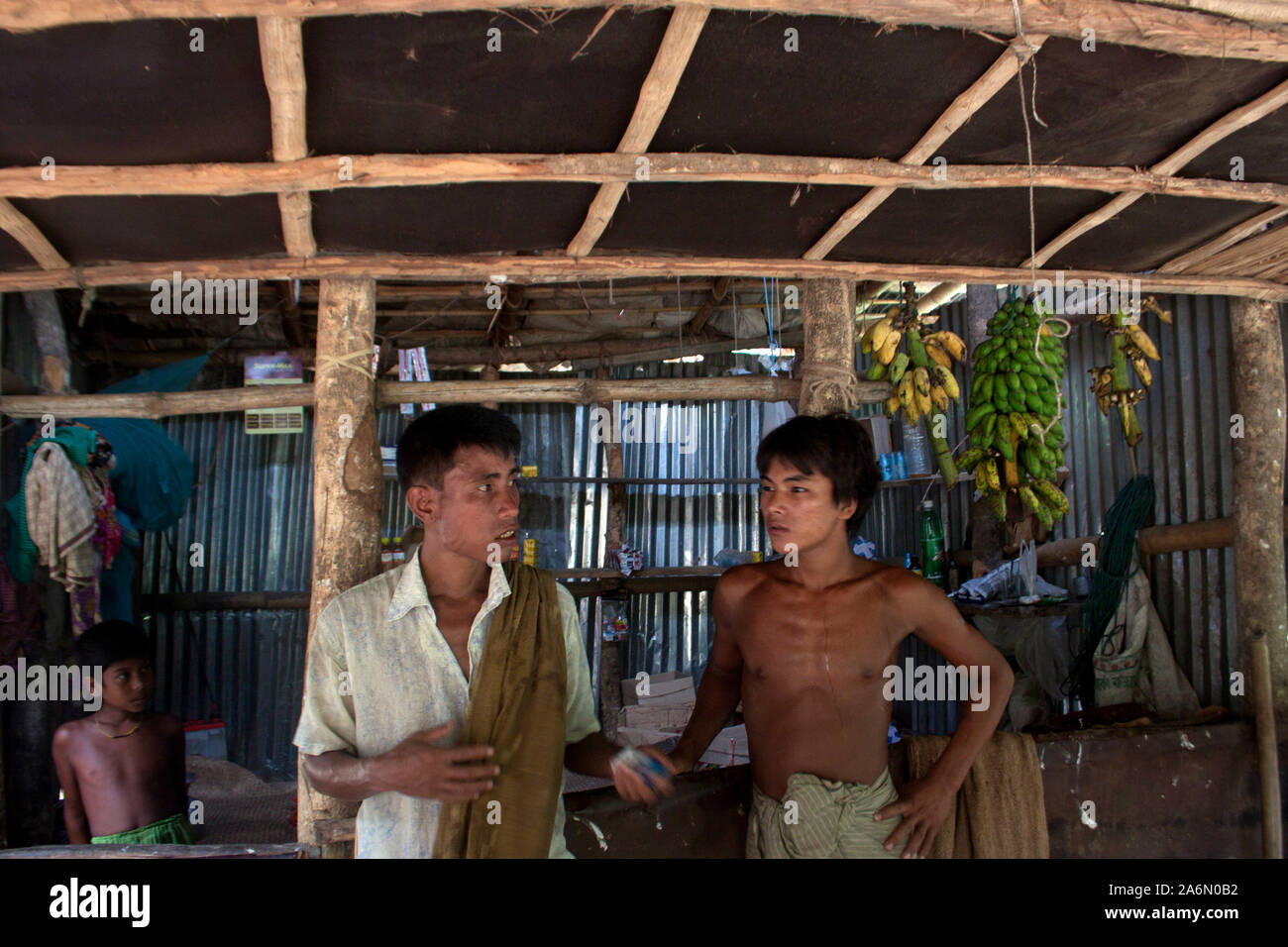 Two young men from the ethnic Murong (also Mru or Mro) community, at a shop, in Lama, Bandarban, Bangladesh. July 28, 2010. Stock Photo