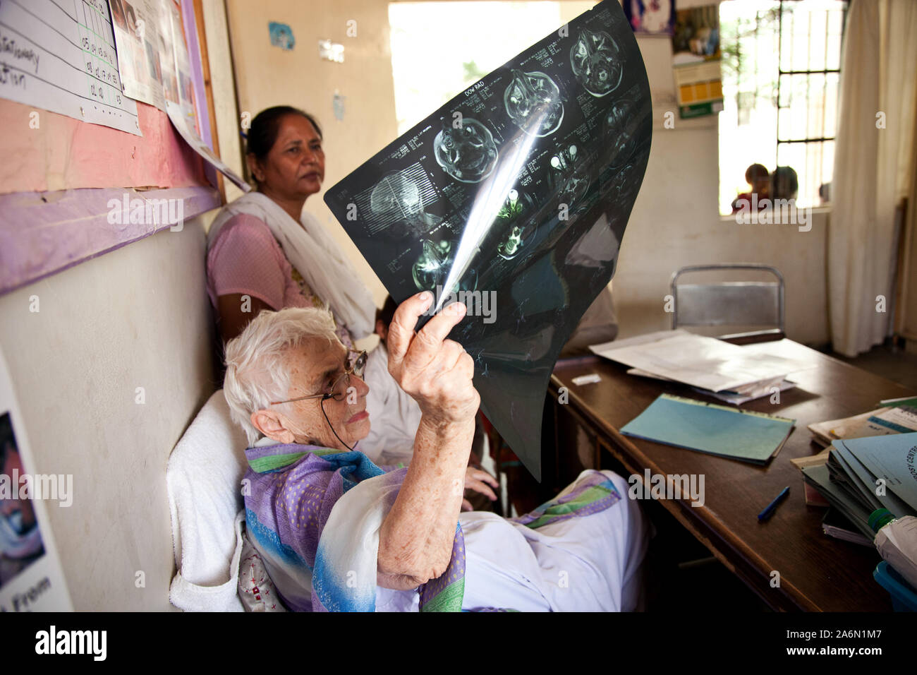 Dr.Ruth Pfau observes a patients X-ray at a centre in Adam Goth, Karachi Stock Photo