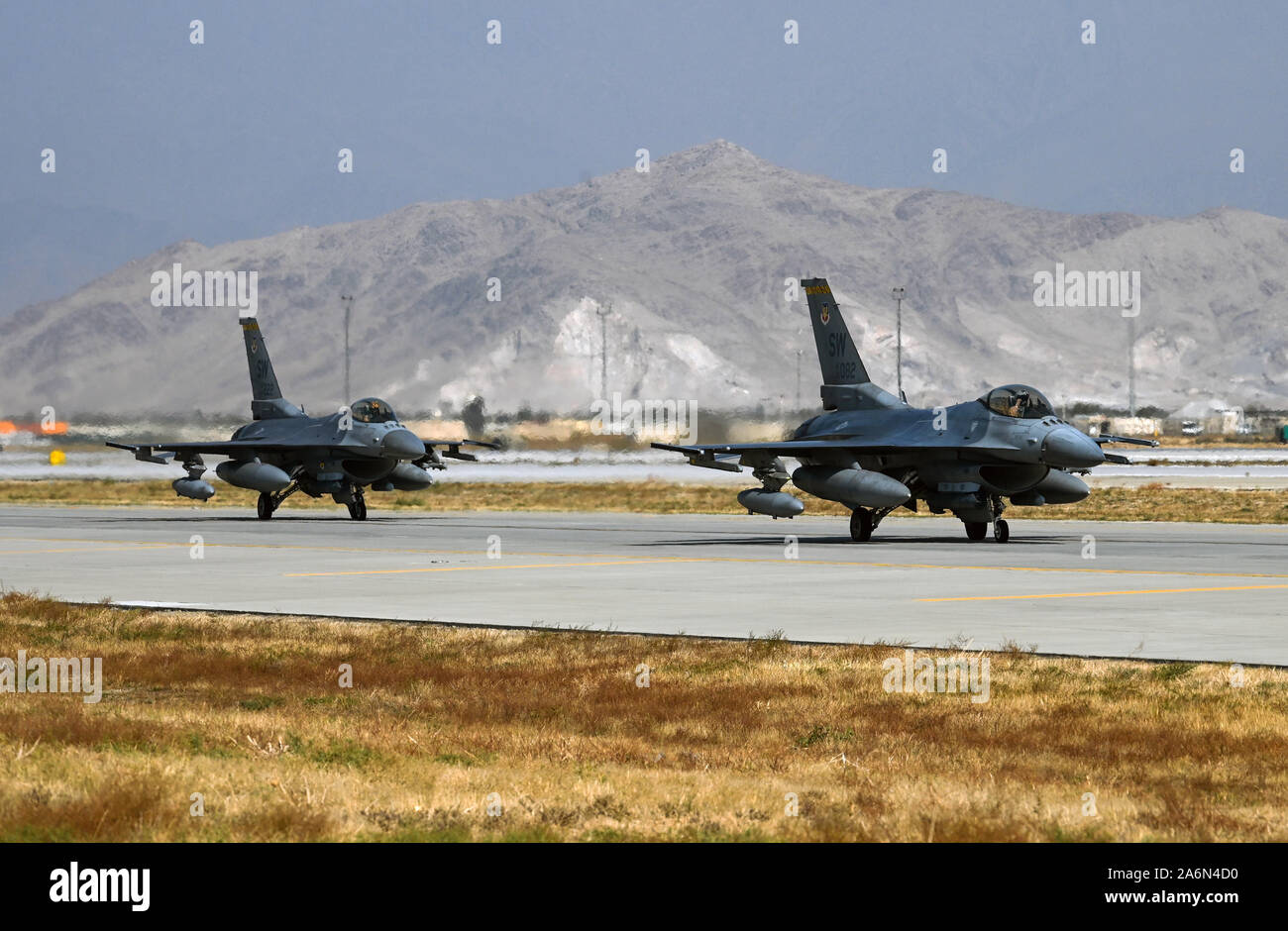 U.S. Air Force F-16 Fighting Falcons from the 79th Fighter Squadron at Shaw Air Force Base, S.C., arrive at Bagram Airfield, Afghanistan, Oct. 26, 2019. While assigned to the 455th Air Expeditionary Wing at Bagram, the F-16s will help provide decisive airpower through the U.S. Central Command area of responsibility. The airpower the wing provides ensures NATO forces can focus on their mission to train, advise and assist. (U.S. Air Force photo by Staff Sgt. Matthew Lotz) Stock Photo