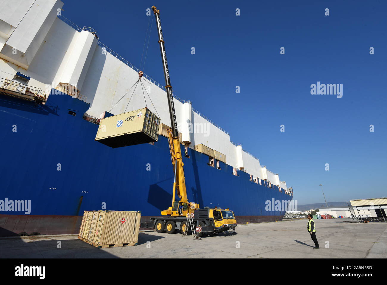 A crane lifts and moves storage containers from the cargo vessel ARC Endurance, at Volos Port, Greece Oct 26, 2019. The crane operation occurred during the 3rd CAB’s deployment (Import) in support of Atlantic Resolve. The aviation brigade was met by several units to include the 21st Theater Sustainment Command, 598th Transportation Brigade, 839th Transportation Battalion and host-nation partners who coordinated port operations to ensure 3CAB’s successful arrival and preparation for onward movement into the European theater. 3CAB will play a critical role in Atlantic Resolve by training closely Stock Photo