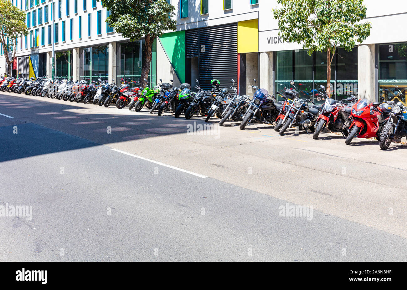 A long line of parked motorcycles in an urban setting Stock Photo Alamy
