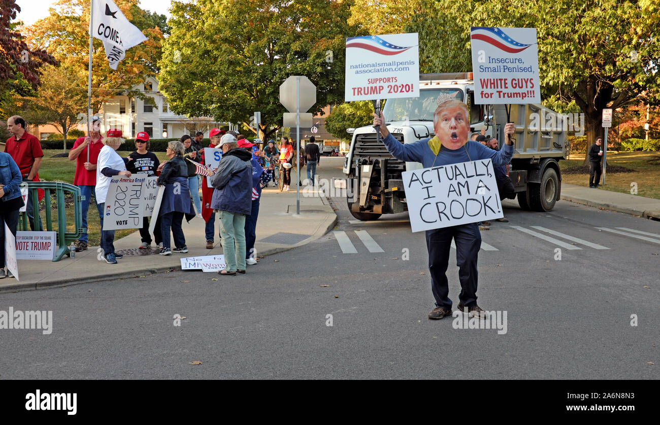 A man with a Trump mask and a sign stating 'Actually I am a Crook' protests in front of Trump supporters in Westerville, Ohio, USA. Stock Photo