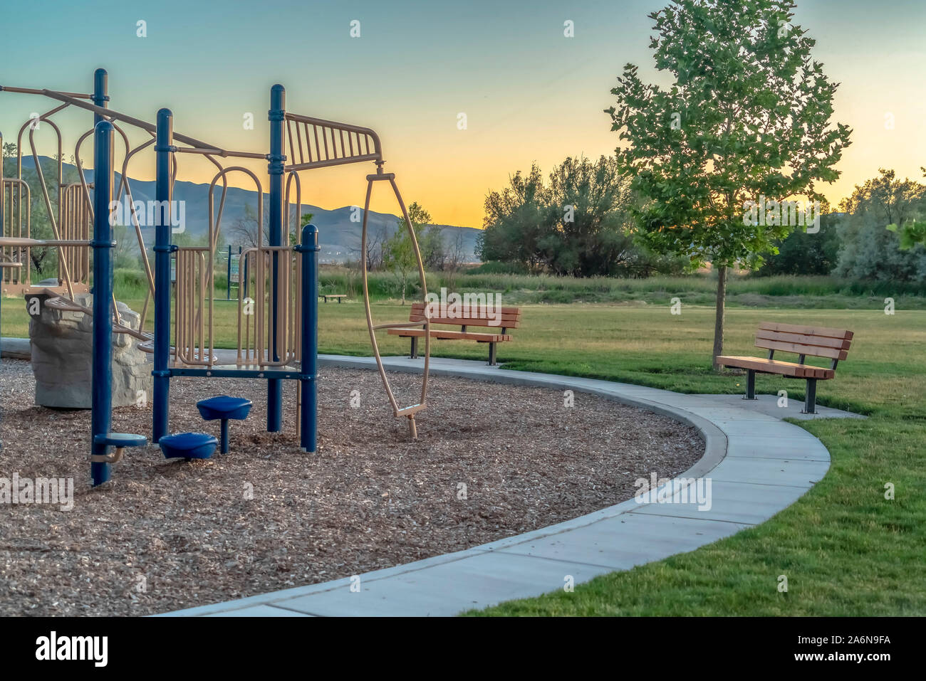 Playground And Benches At A Park Against Trees Mountain And Sky At Sunset Stock Photo Alamy