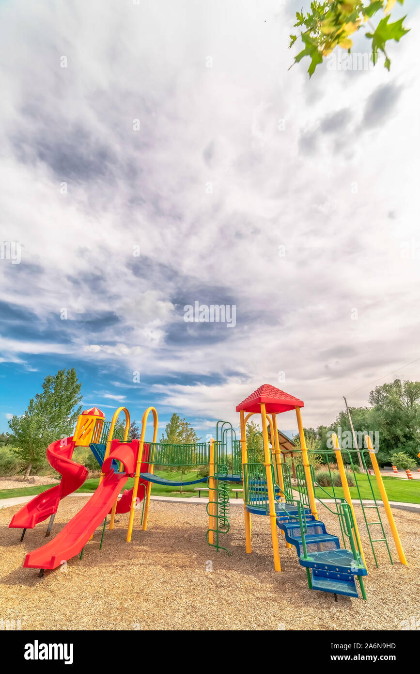 Bright Colorful Childrens Playground Under Blue Sky And Clouds On A Sunny Day Stock Photo Alamy alamy