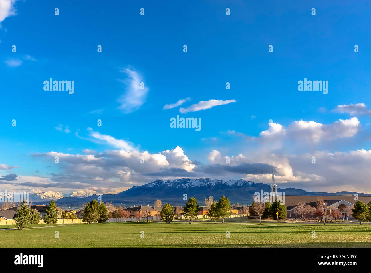 Green countryside landscape with blue sky and clouds Stock Photo