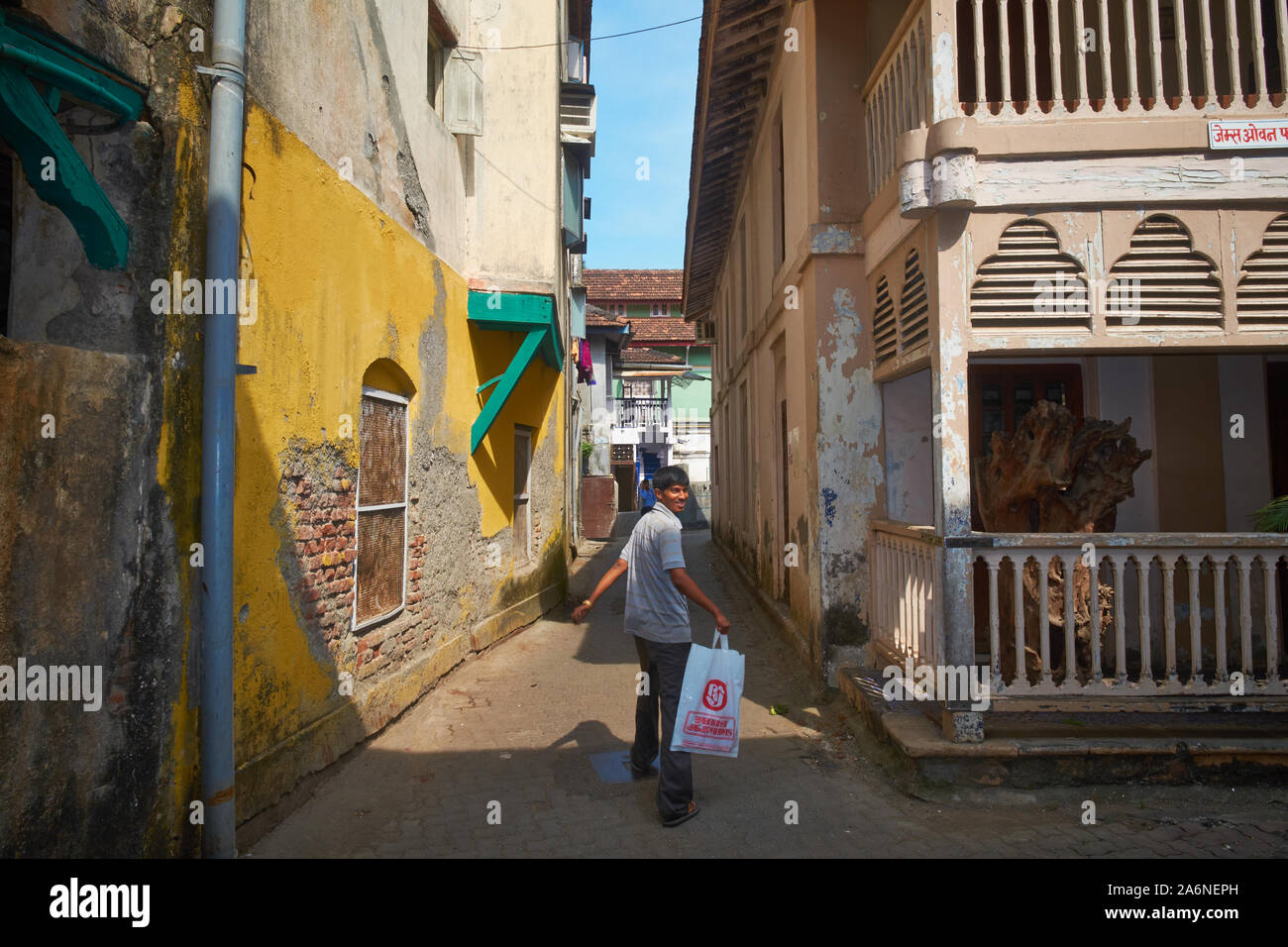 A boy walks through a lane in Kotachiwadi heritage area, partly a Christian enclave with old Portuguese-style houses; Mumbai, India Stock Photo