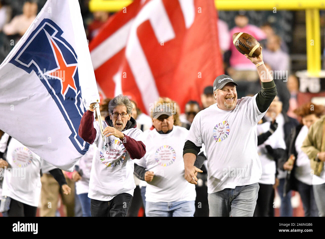 Philadelphia, Pennsylvania, USA. 26th Oct, 2019. Cancer survivors carry the American Athletic Conference flag onto the field prior to the football game played at Lincoln Financial Field in Philadelphia. UCF beat Temple 63-21. Credit: Ken Inness/ZUMA Wire/Alamy Live News Stock Photo