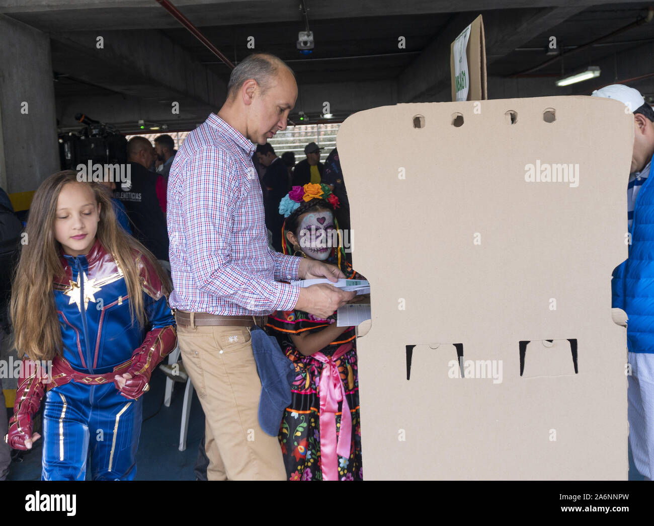 Bogota, Colombia. 27 Oct, 2019. Some girls in disguise waits while her father voting in local and regional elections in Bogota. Credit: Daniel Garzon Herazo/ZUMA Wire/Alamy Live News Stock Photo