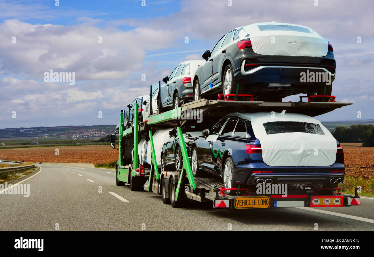 The trailer is engaged in the delivery of new cars to their place of sales Stock Photo