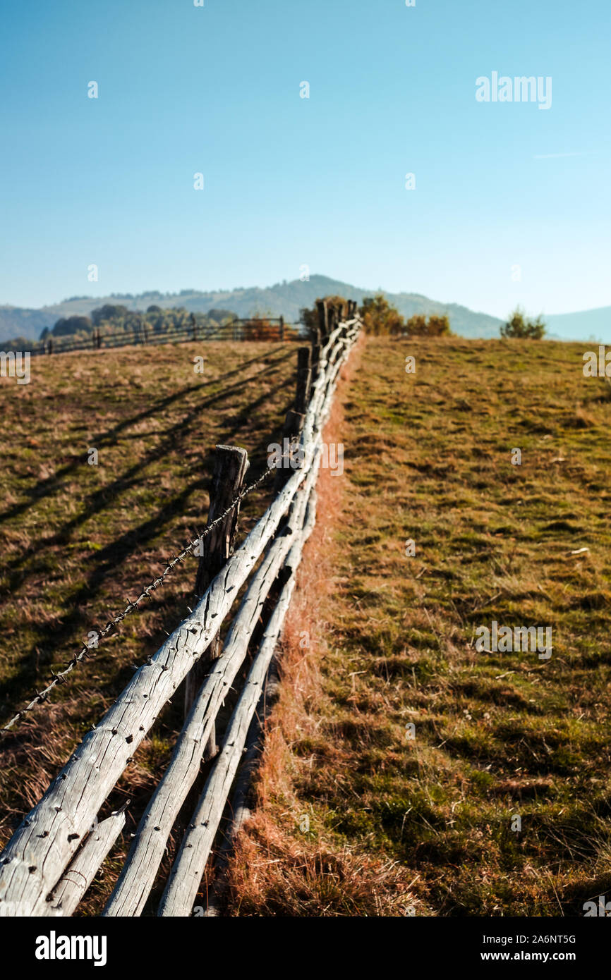 old wooden fence with barbed wire Stock Photo - Alamy