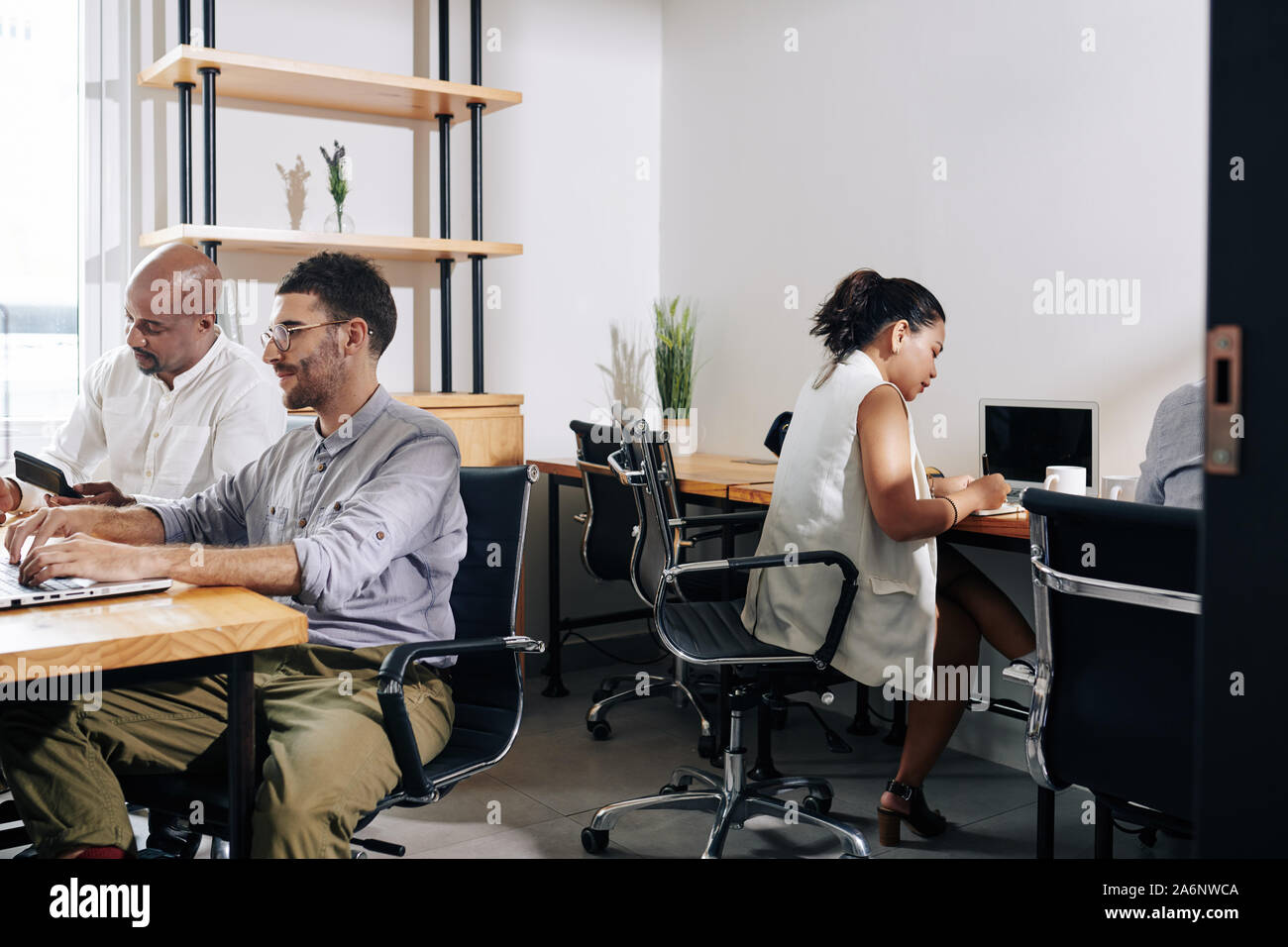 Young multi-ethnic project managers working in modern office Stock Photo