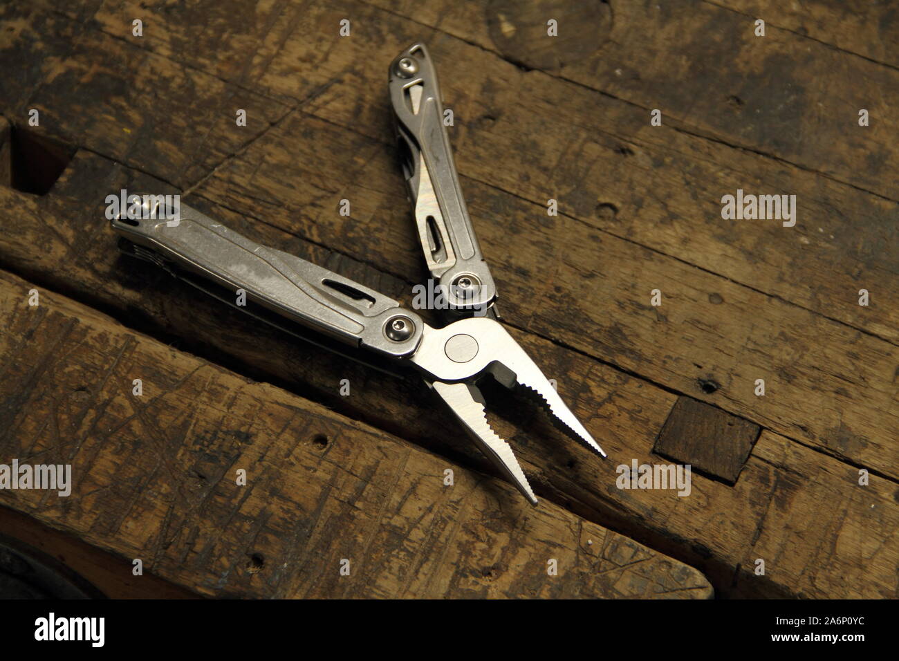 a multitool on the workbench Stock Photo