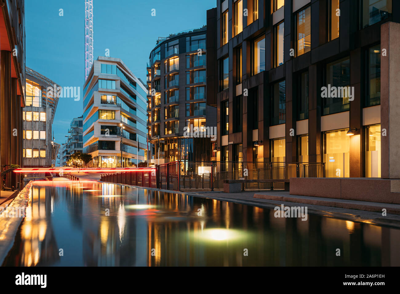 Oslo, Norway - June 24, 2019: Night View Embankment And Residential Multi-storey Houses In Tjuvholmen District. Summer Evening. Residential Area Refle Stock Photo