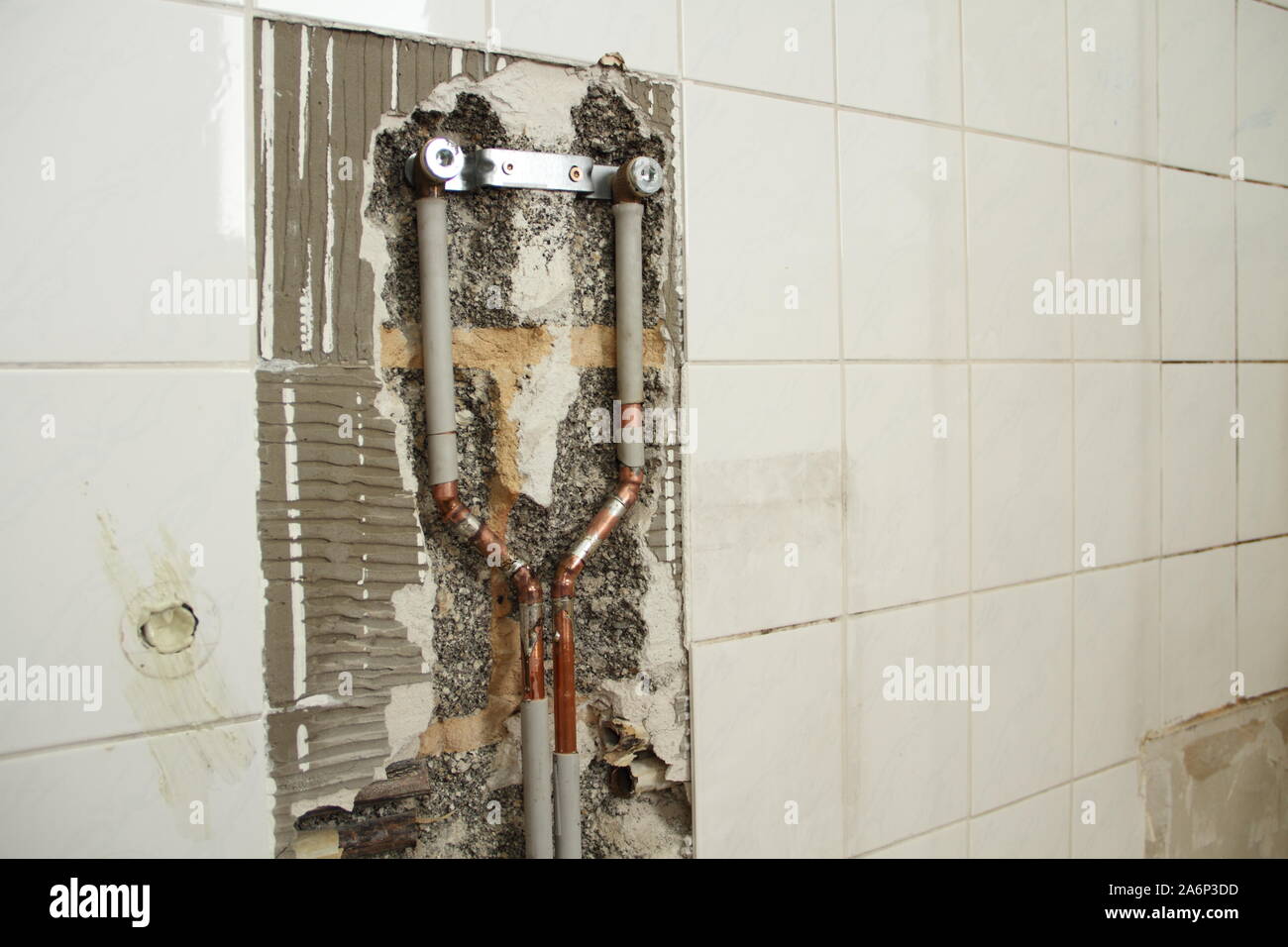 a new water pipe is laid in the bathroom Stock Photo