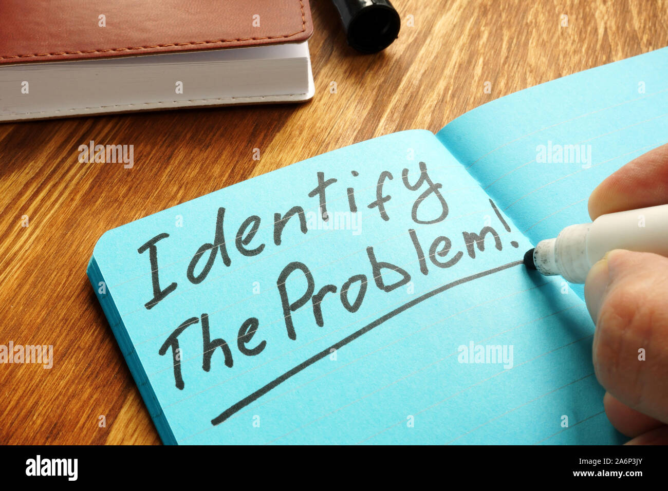 Identify the problem sign on the blue page. Stock Photo