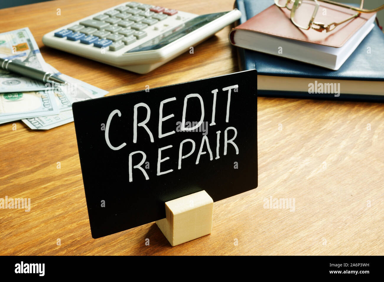Credit Repair plate in the office. Debt problems concept. Stock Photo