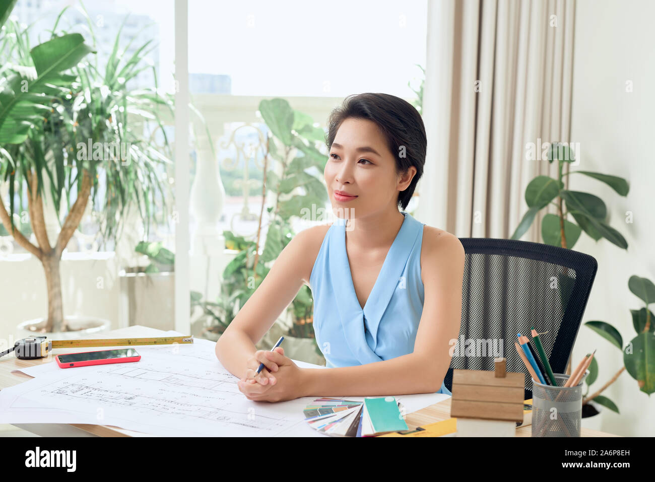 Young Asian woman working on engineering project Stock Photo