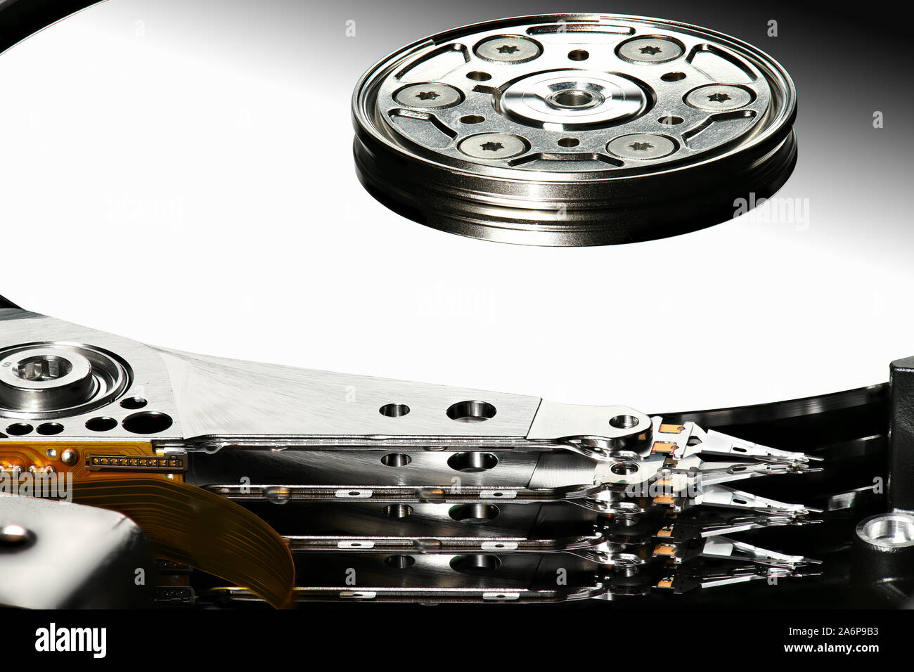 Disassembled computer hard disk drive, hdd with mirror effect. Macro photo. Opened hard drive