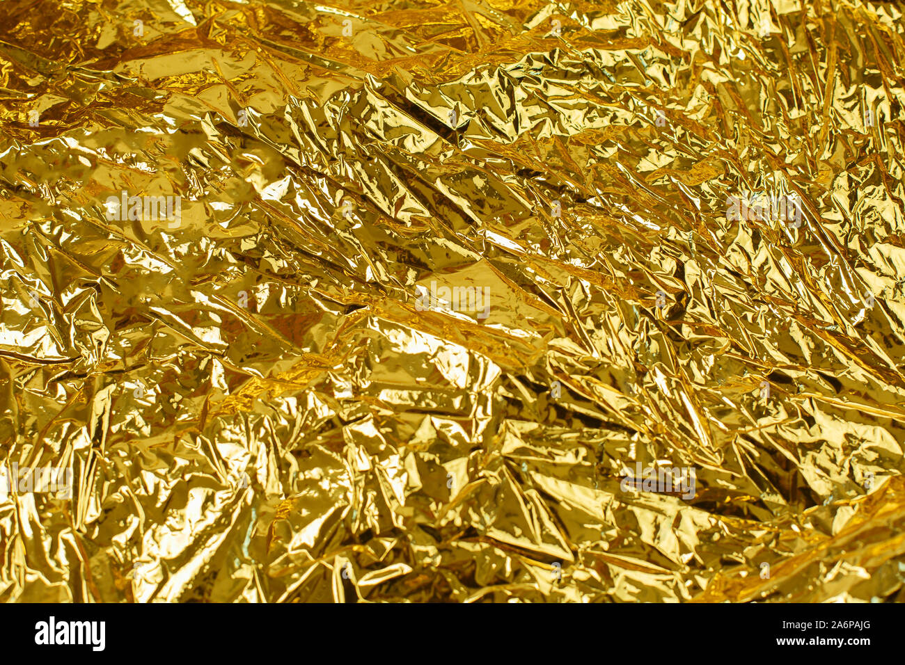 Gold leaf background texture with shiny crumpled uneven surface Stock Photo