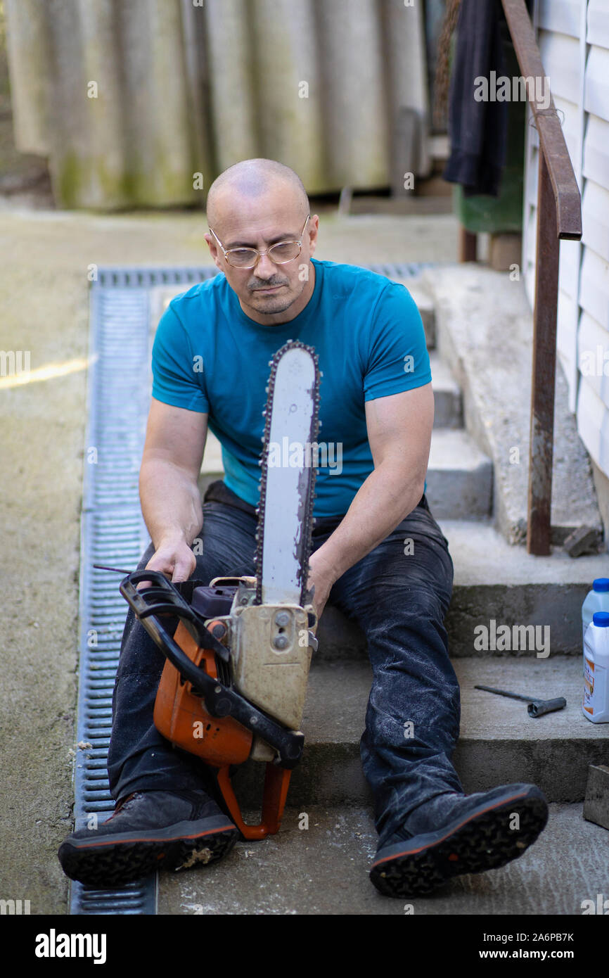 Sharpening a chainsaw Close up on a man sharpening a chainsaw chain with file Stock Photo Alamy
