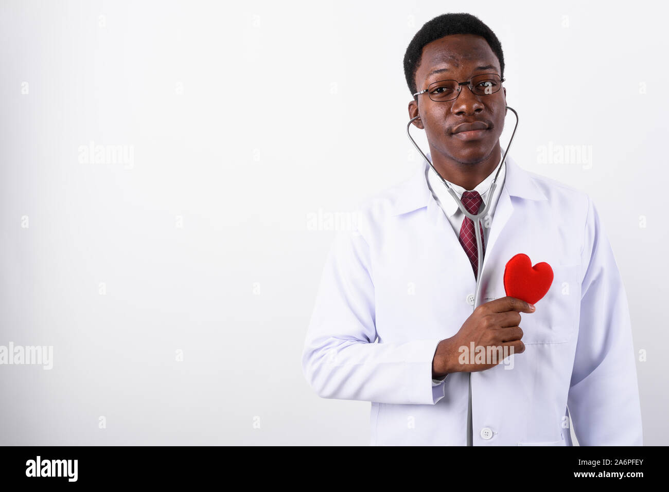 Young handsome African man doctor wearing eyeglasses against whi Stock Photo
