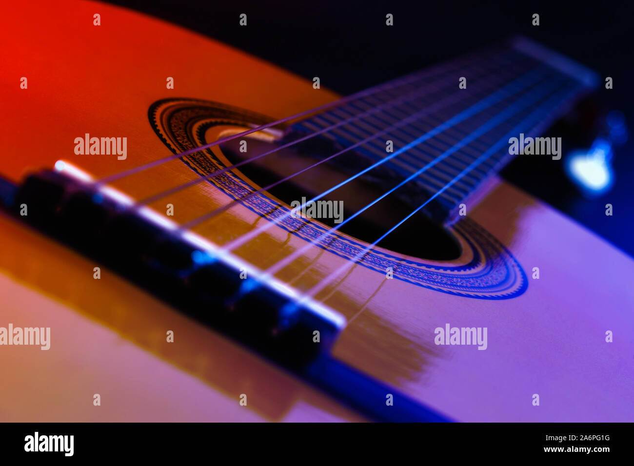Guitar backlit with colorful highlights, close-up with shallow depth of field. Stock Photo