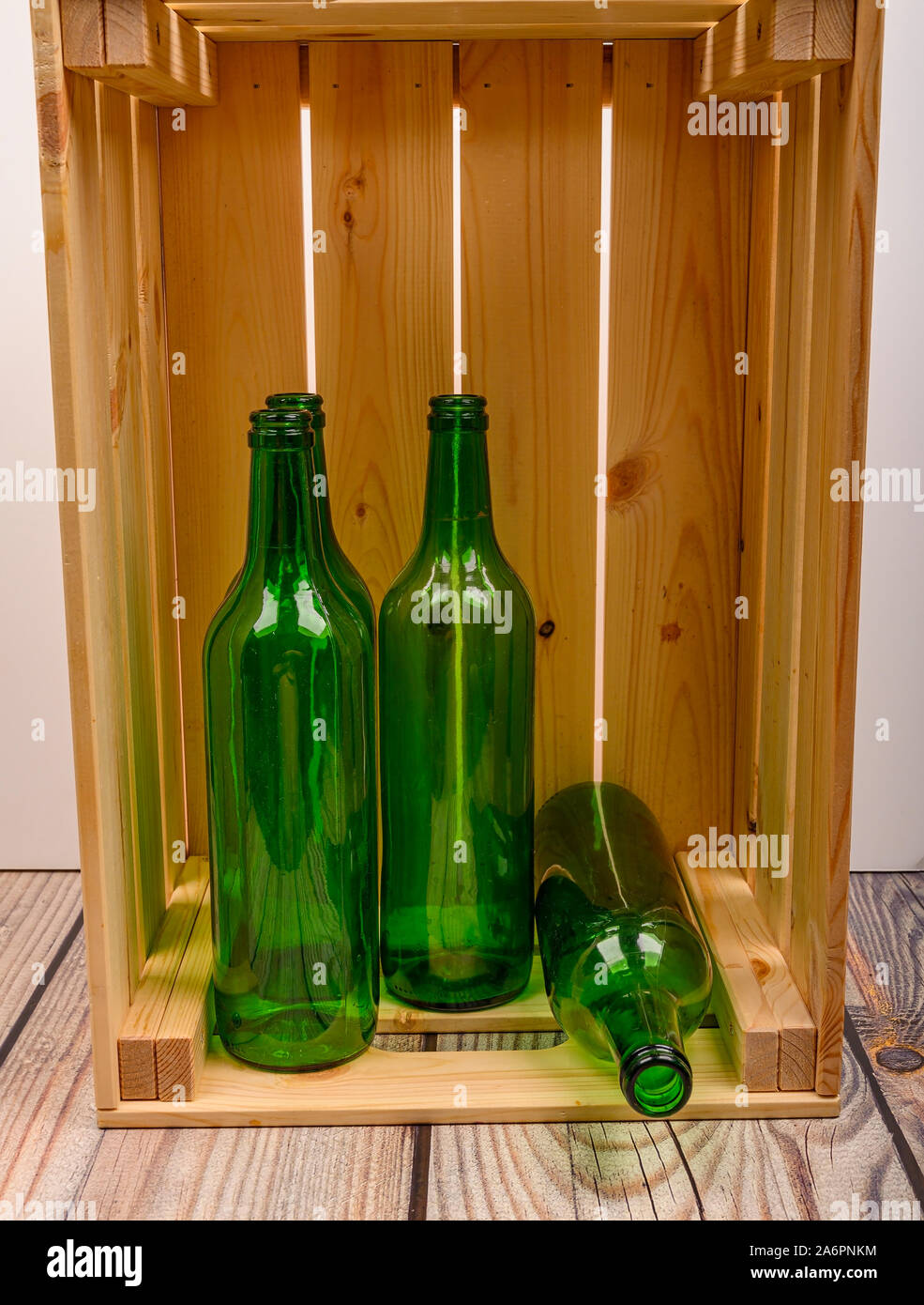 Empty wine bottles in a wooden box on the table. Home winemaking Stock Photo