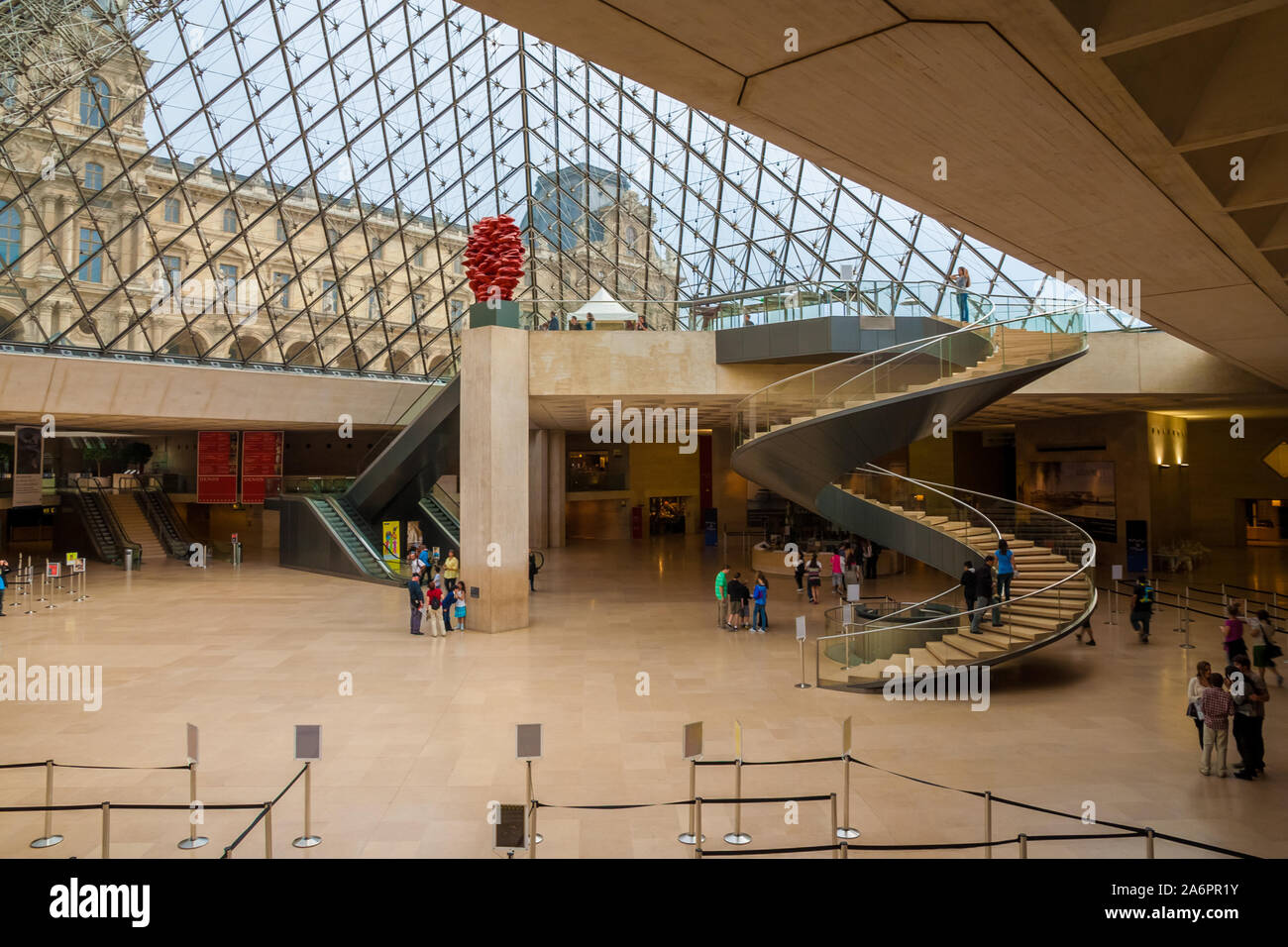 Great overview of the underground lobby of the Louvre Museum in Paris inside the Pyramid with an impressive spiral staircase. Stock Photo