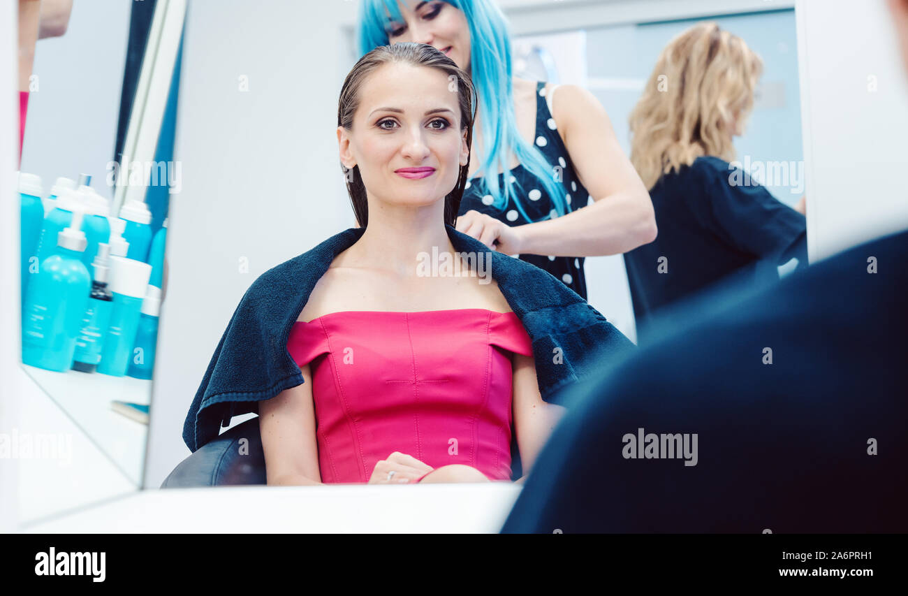 Customer getting a hairdo competently carried out by stylist Stock Photo
