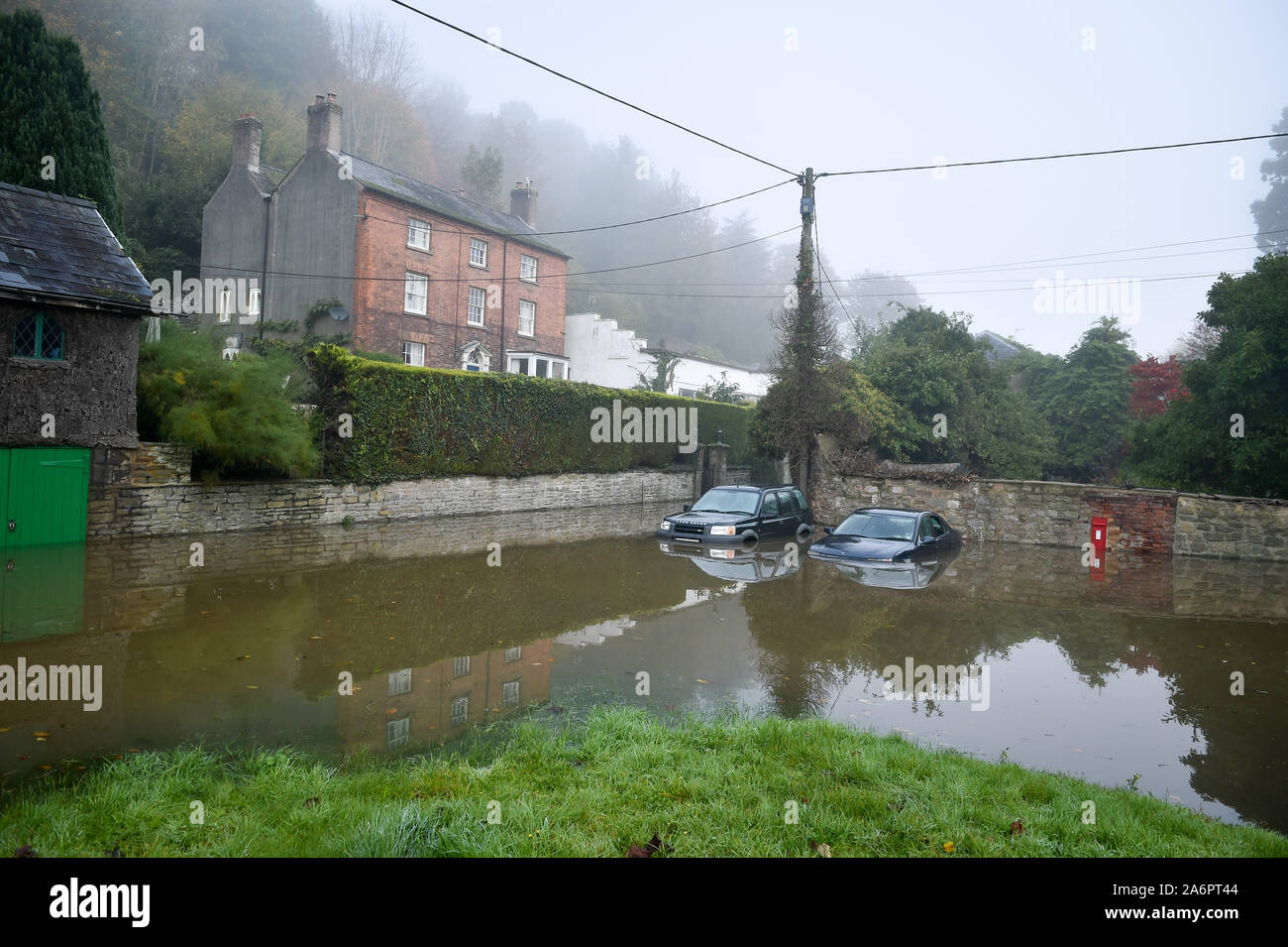 Cars are submerged in Lower Lydbrook, where rain from the Welsh hills and high tides have flooded the village, which sits next to the banks of the River Wye, rendering it impassable. Stock Photo