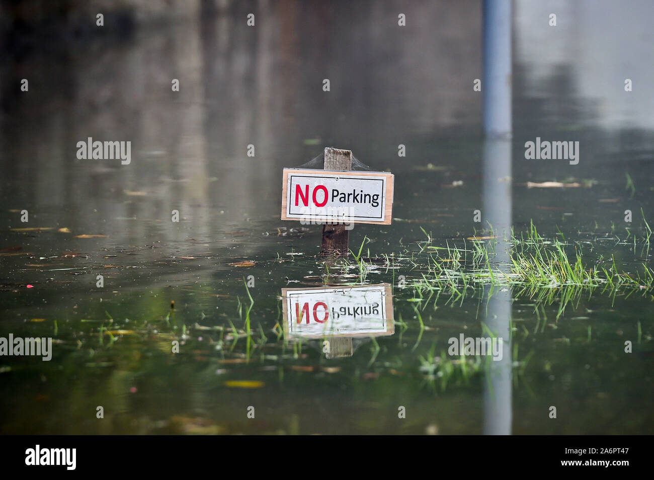 A no parking sign is submerged in Lower Lydbrook, where rain from the Welsh hills and high tides have flooded the village, which sits next to the banks of the River Wye, rendering it impassable. Stock Photo