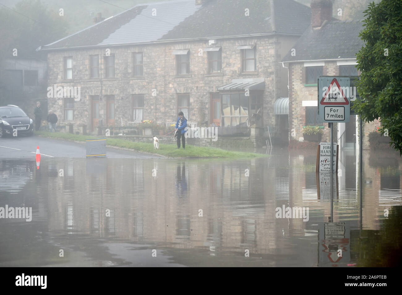 Flooded streets and the B4234 main road in Lower Lydbrook, where rain from the Welsh hills and high tides have flooded the village, which sits next to the banks of the River Wye, rendering it impassable. Stock Photo