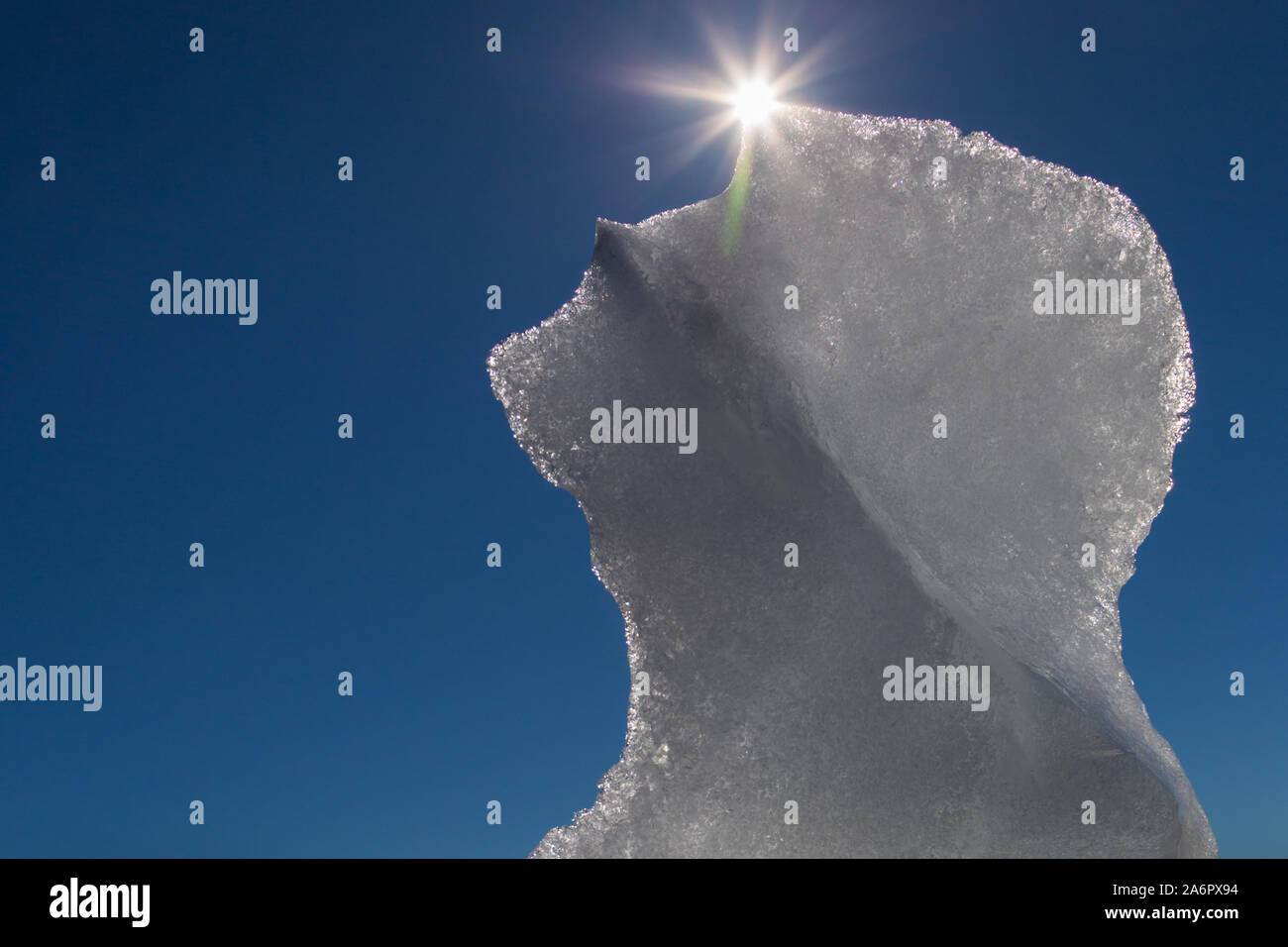 melting ice floe with sun and sunbeams and blue sky Stock Photo